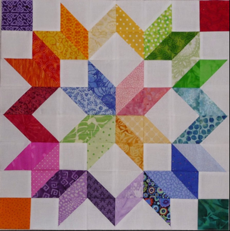 A brightly colored Carpenter's Wheel quilt block